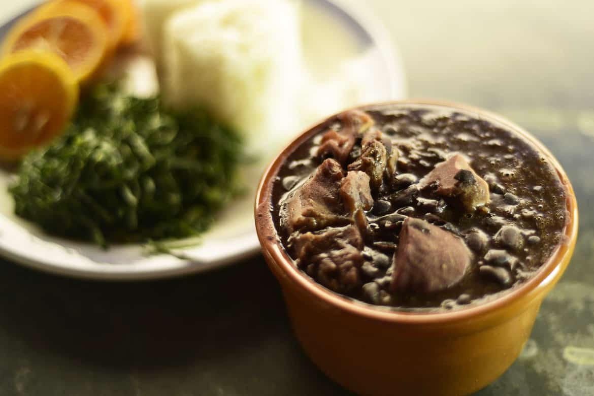 A bowl of feijoada, a Brazilian dish of black beans and meat.